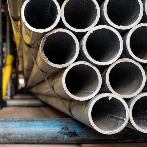 Rolled metal stock stacked in an industrial facility