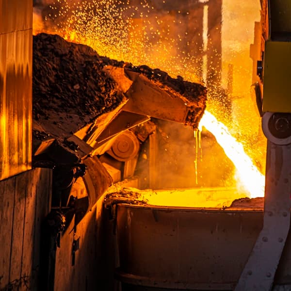 Rolled metal stock stacked in an industrial facility