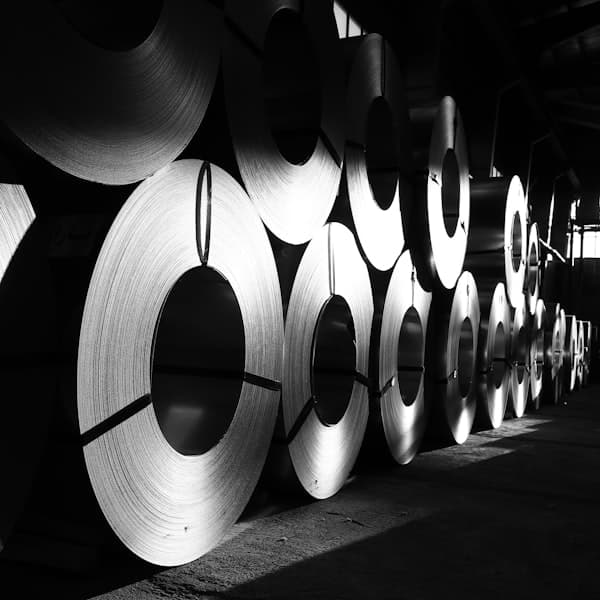 Rolled metal stock stacked in an industrial facility