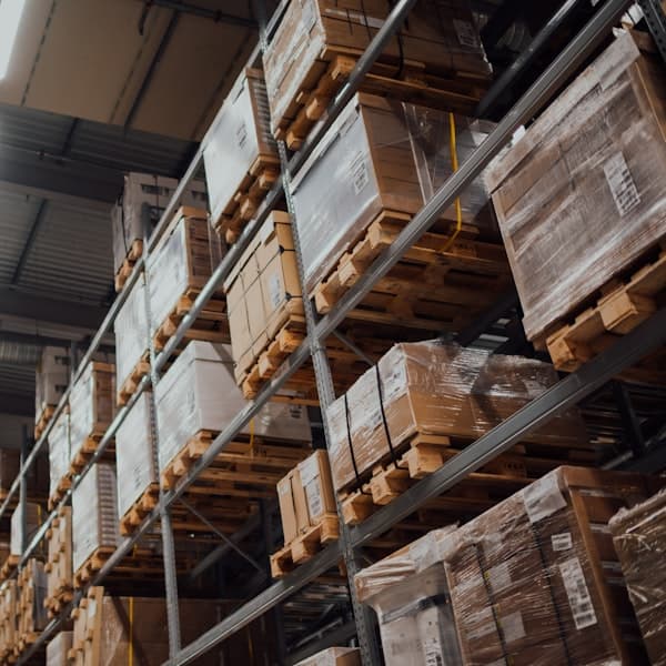 Palletised metal stock staged for shipment in a warehouse