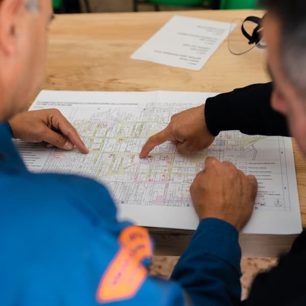Engineering drawings and measuring tools on a bench