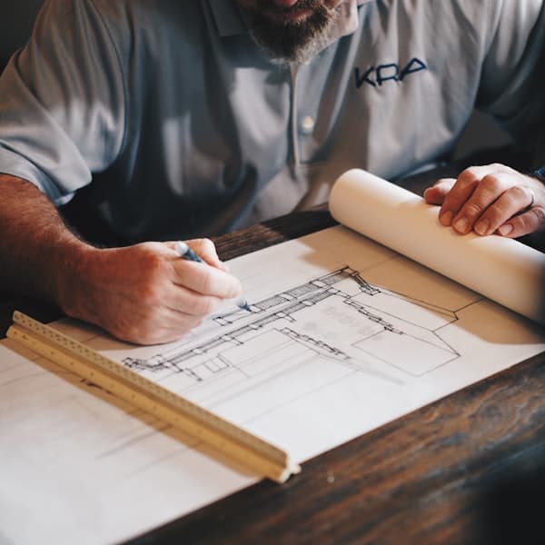 Engineering drawings and measuring tools on a bench