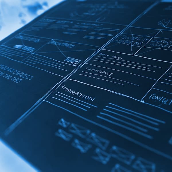 Engineering drawings and measuring tools on a bench